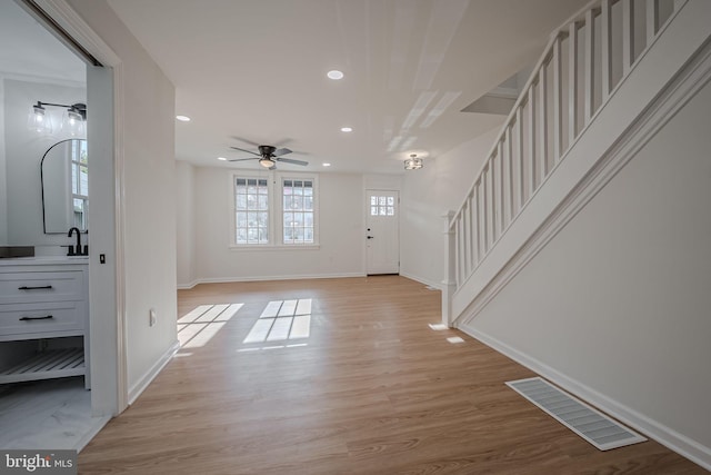 entrance foyer with ceiling fan and light hardwood / wood-style floors