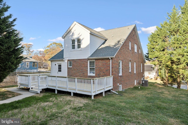 back of house with cooling unit, a lawn, and a deck