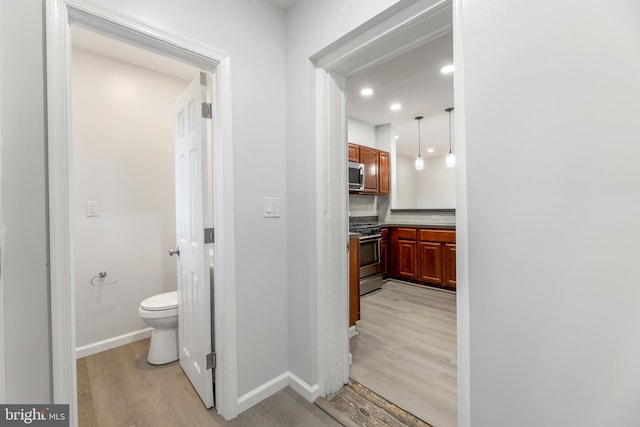 bathroom featuring hardwood / wood-style flooring and toilet