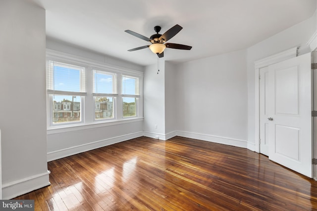 empty room featuring dark hardwood / wood-style floors and ceiling fan