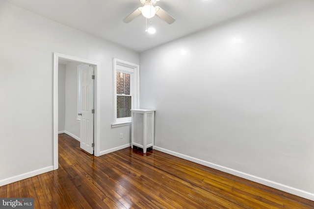 spare room with ceiling fan and dark hardwood / wood-style flooring