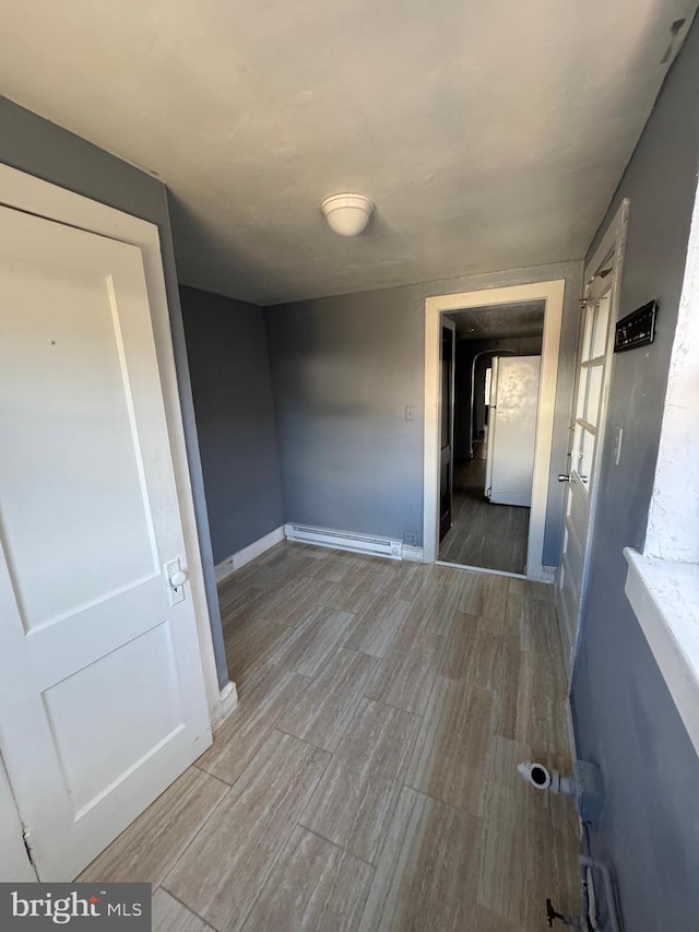 interior space featuring a baseboard radiator and wood-type flooring