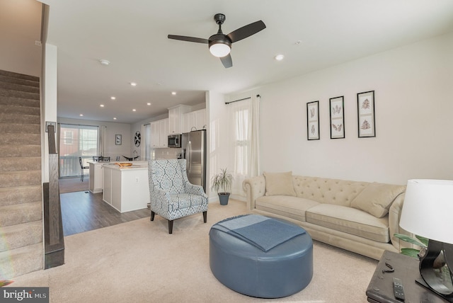 living room with ceiling fan and light hardwood / wood-style floors