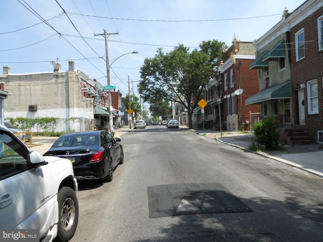 2304 N 25th St, Philadelphia, PA 19132 - view of asphalt road with traffic signs, sidewalks, curbs, and street lighting