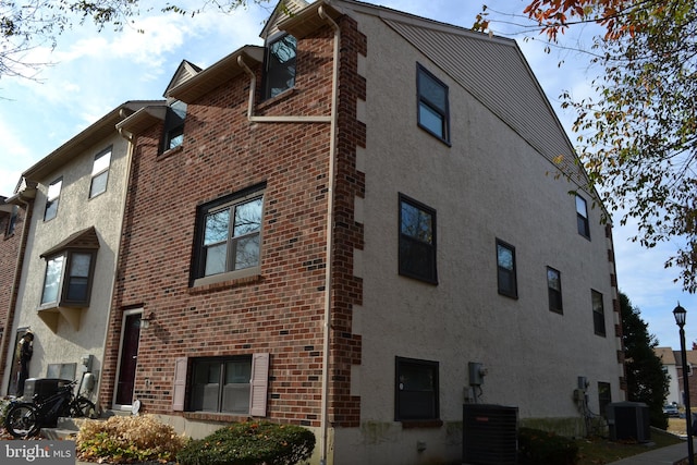 view of building exterior with central AC unit