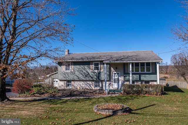 raised ranch featuring a front lawn