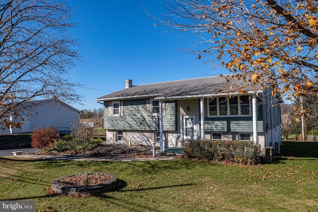 raised ranch with a front yard