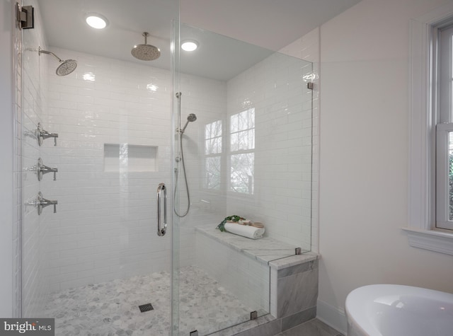 bathroom with shower with separate bathtub