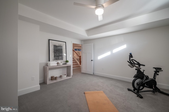 workout area with ceiling fan and carpet