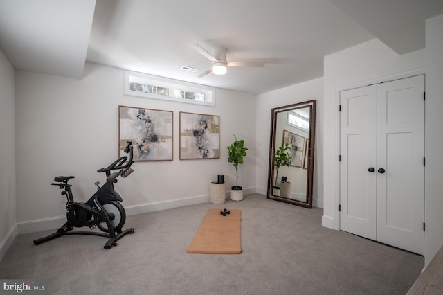 exercise area featuring ceiling fan and light colored carpet