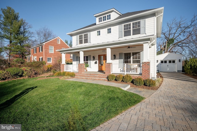 view of front of house with covered porch, a garage, an outdoor structure, and a front lawn