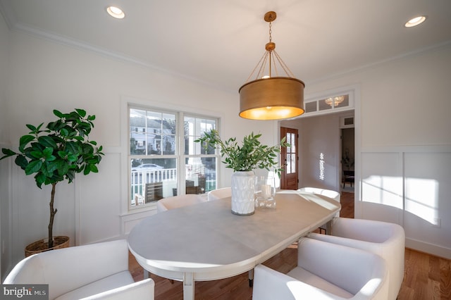 dining room with crown molding and wood-type flooring