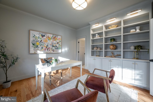 home office featuring light wood-type flooring and ornamental molding