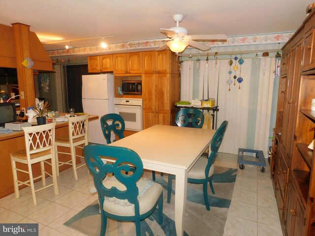 dining room featuring light tile patterned floors and ceiling fan