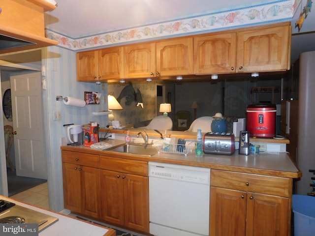 kitchen featuring sink, white dishwasher, and light tile patterned floors