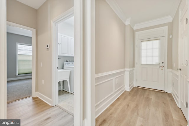 interior space with ornamental molding, light hardwood / wood-style flooring, and sink