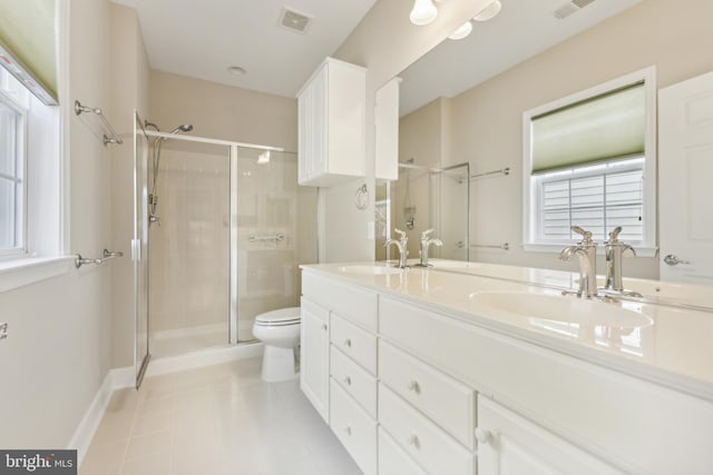 bathroom with toilet, vanity, tile patterned floors, and a shower with door