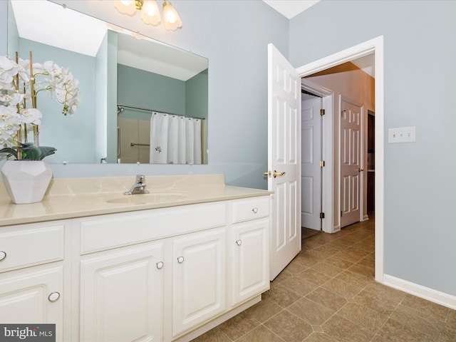 bathroom with a shower with curtain, tile patterned flooring, and vanity