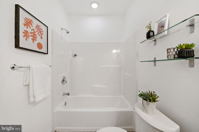 bathroom with toilet and bathing tub / shower combination