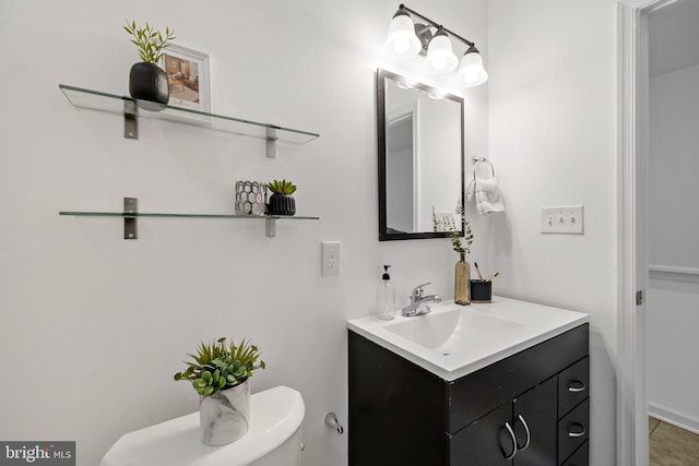 bathroom featuring vanity, tile patterned floors, and toilet