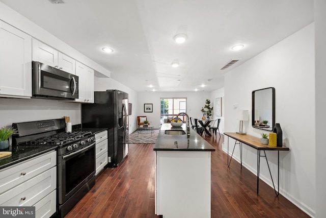 kitchen featuring white cabinetry, appliances with stainless steel finishes, sink, and dark hardwood / wood-style floors