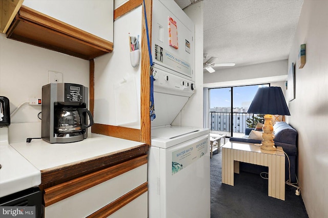 kitchen featuring ceiling fan, a textured ceiling, carpet flooring, white cabinets, and stacked washer and dryer