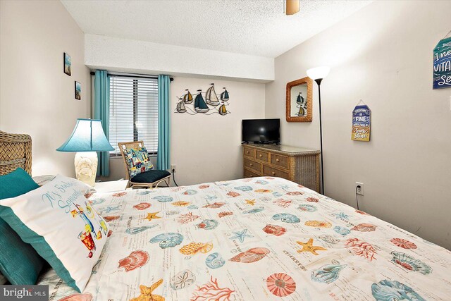 bedroom featuring a textured ceiling and ceiling fan