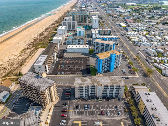 birds eye view of property featuring a water view and a beach view