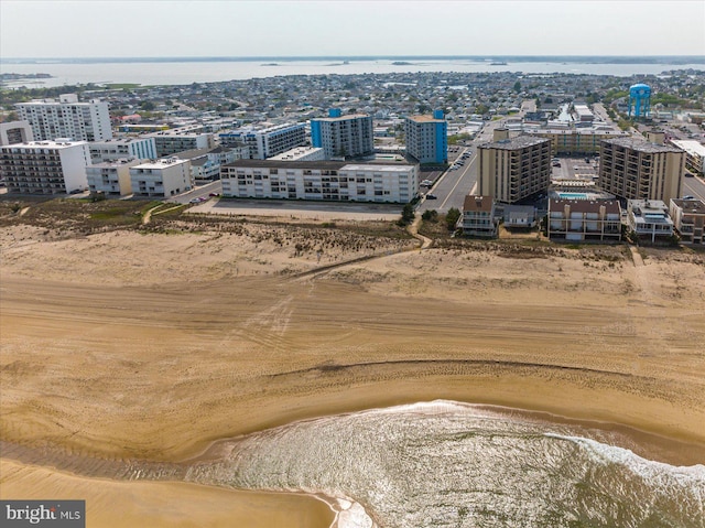 drone / aerial view featuring a beach view and a water view