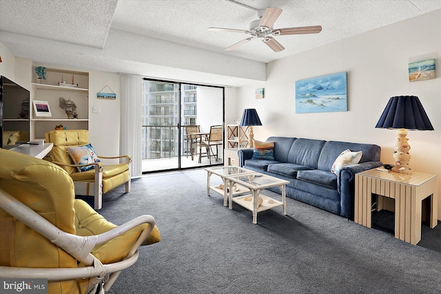 carpeted living room with a textured ceiling and ceiling fan