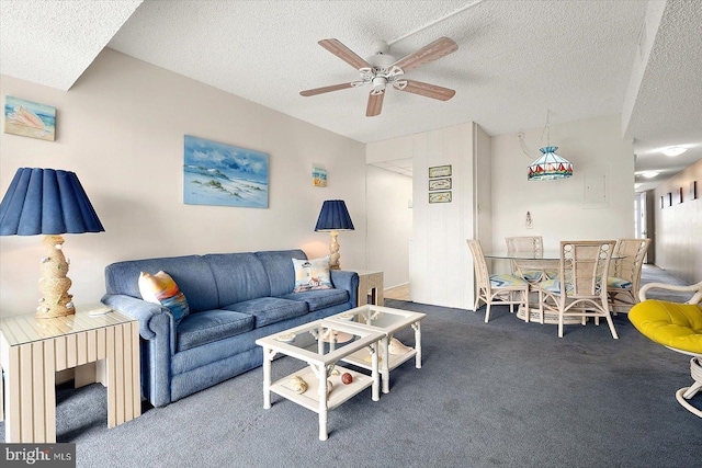 living room with carpet floors, a textured ceiling, and ceiling fan