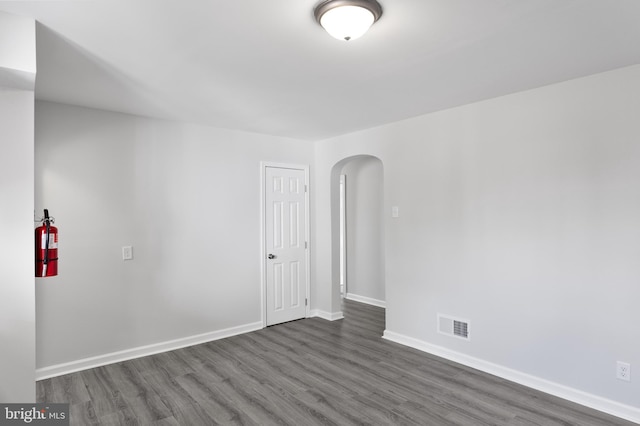 spare room featuring dark wood-type flooring