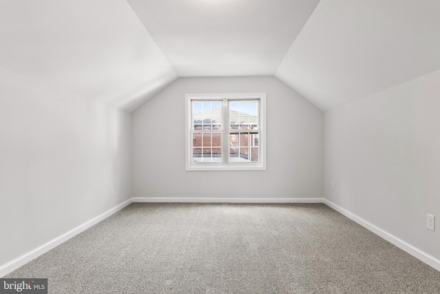 bonus room featuring carpet flooring and vaulted ceiling