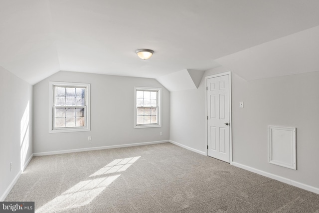 additional living space with lofted ceiling and light colored carpet