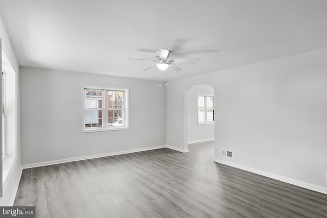 unfurnished room featuring dark hardwood / wood-style flooring and ceiling fan