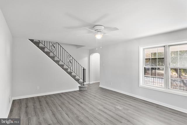 unfurnished living room featuring wood-type flooring and ceiling fan