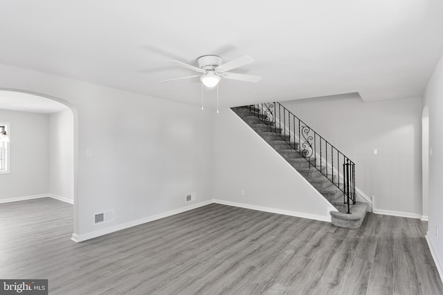 unfurnished living room featuring wood-type flooring and ceiling fan