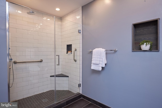 bathroom with a shower with shower door and tile patterned floors