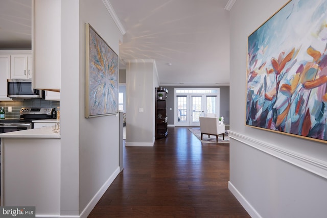 hallway featuring dark wood-type flooring, french doors, and crown molding