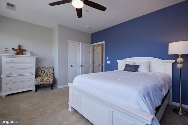 carpeted bedroom with a closet and ceiling fan