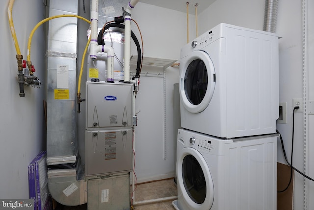 washroom with stacked washer / dryer and heating unit