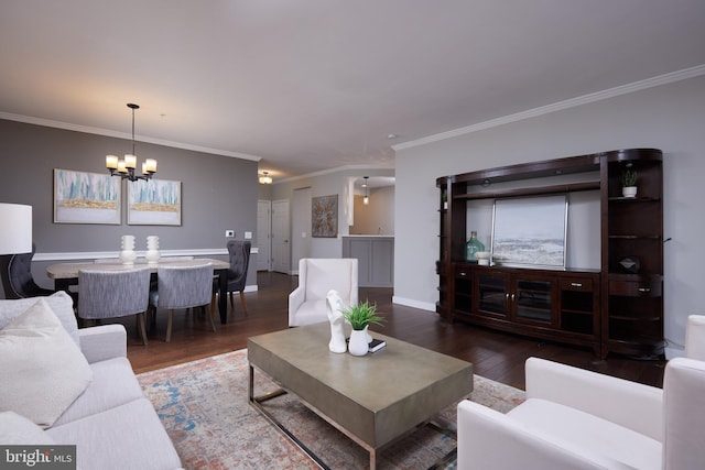 living room featuring dark wood-type flooring, a chandelier, and crown molding