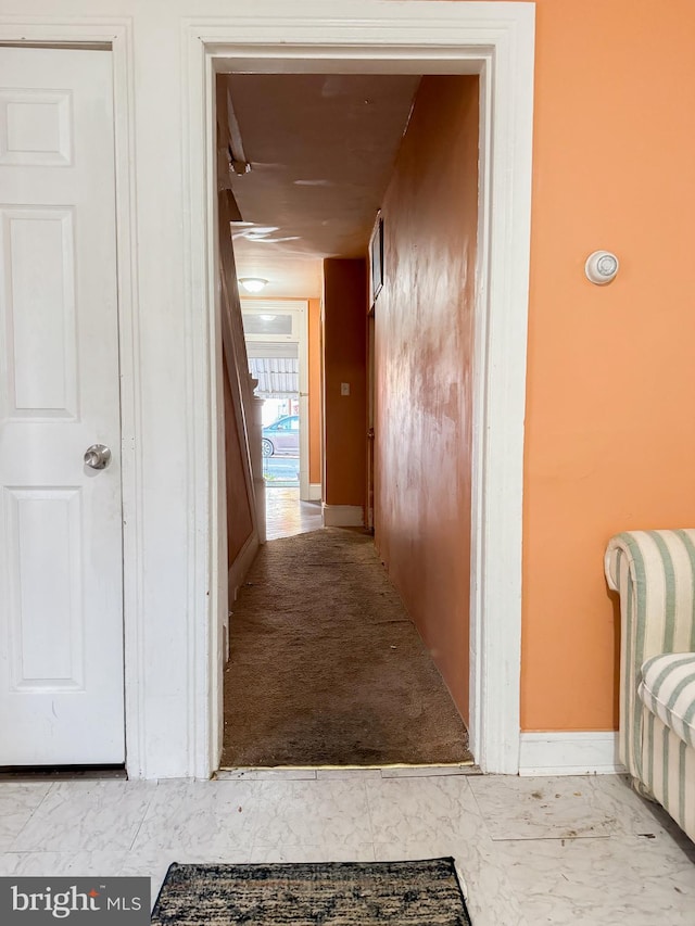 hall featuring light colored carpet