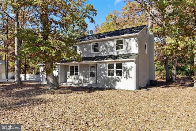 traditional-style home featuring fence