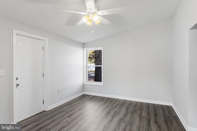 empty room with dark wood-type flooring, ceiling fan, baseboards, and lofted ceiling