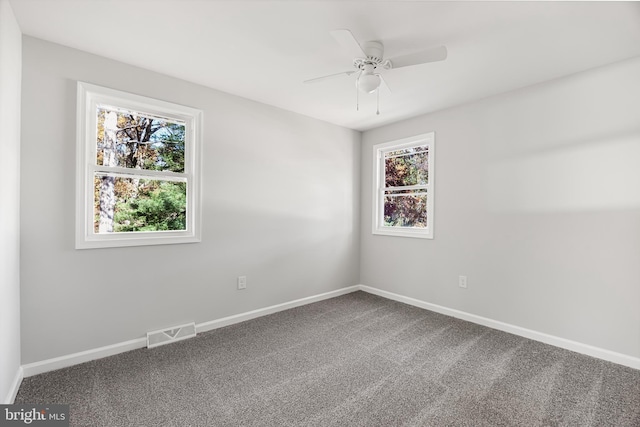 spare room featuring healthy amount of natural light, baseboards, and ceiling fan