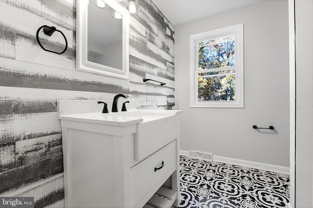 bathroom featuring vanity, baseboards, and tile patterned floors
