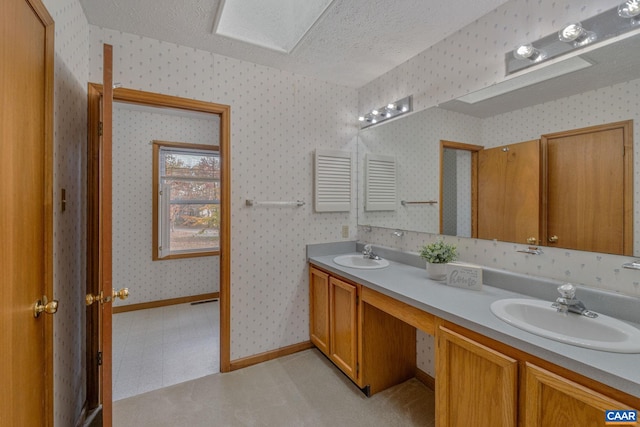 bathroom featuring vanity and a textured ceiling