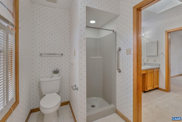 bathroom featuring vanity, walk in shower, tile patterned floors, and toilet