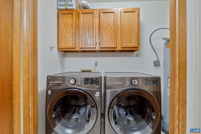 laundry area with cabinets and washer and clothes dryer